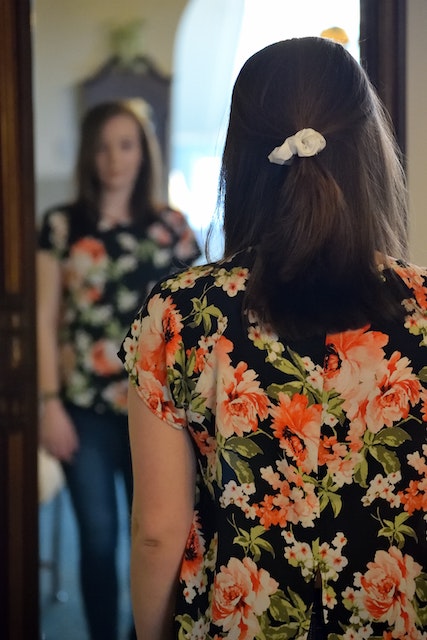 woman standing in front of a mirror